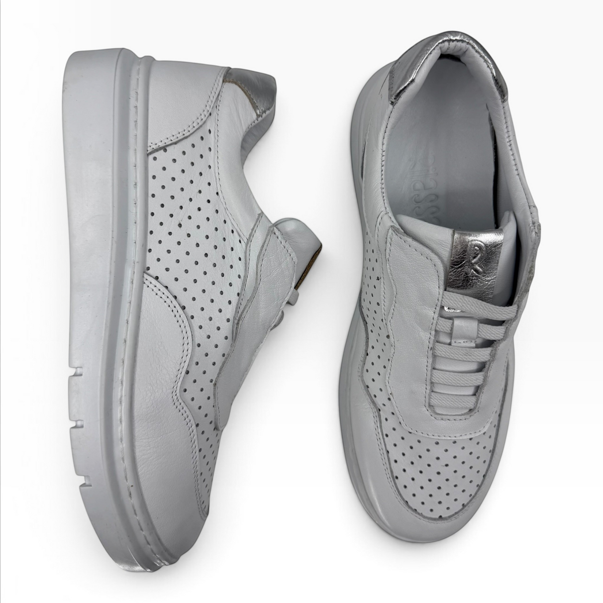 The Shoe Shop Taurus slip-on sneakers in white perforated leather with a metallic heel accent and platform sole.