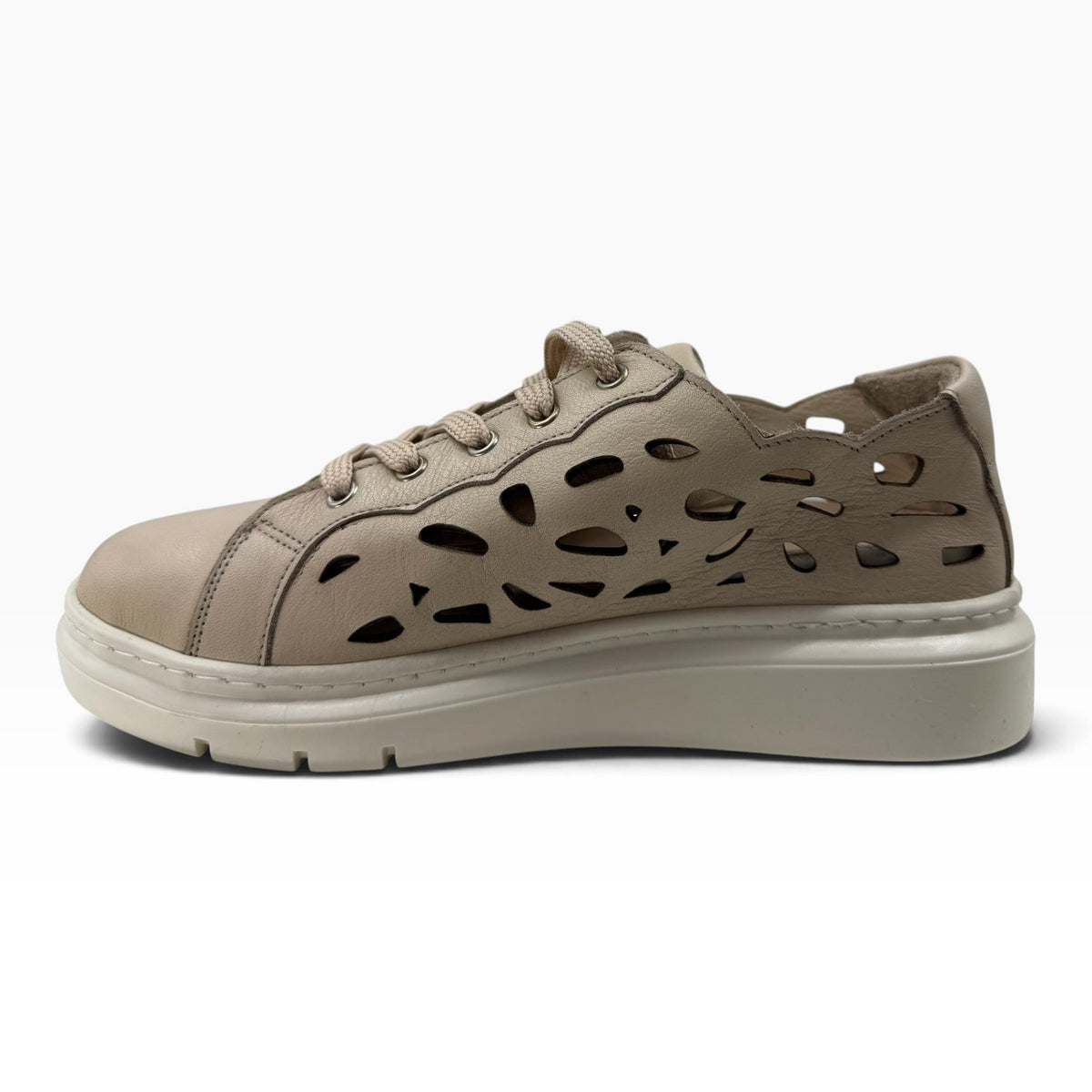 The Shoe Shop Tira sneaker in beige faux leather with laser-cut side panels and a cushioned platform sole.