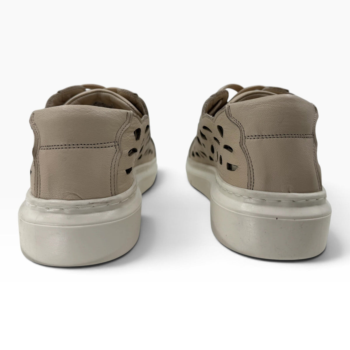 The Shoe Shop Tira sneakers in beige faux leather with laser-cut detailing and a cushioned platform sole, back view.