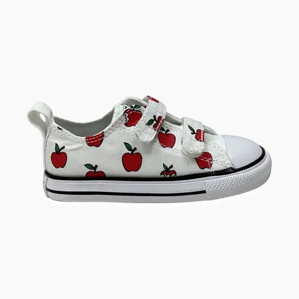 The Shoe Shop toddler Chuck Taylor All Star sneakers in white canvas with a red apple print and dual velcro straps.