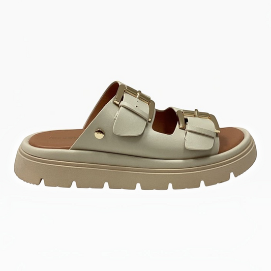 The Shoe Shop Toledo Slide in cream with twin adjustable gold buckle straps and a chunky platform lug sole.