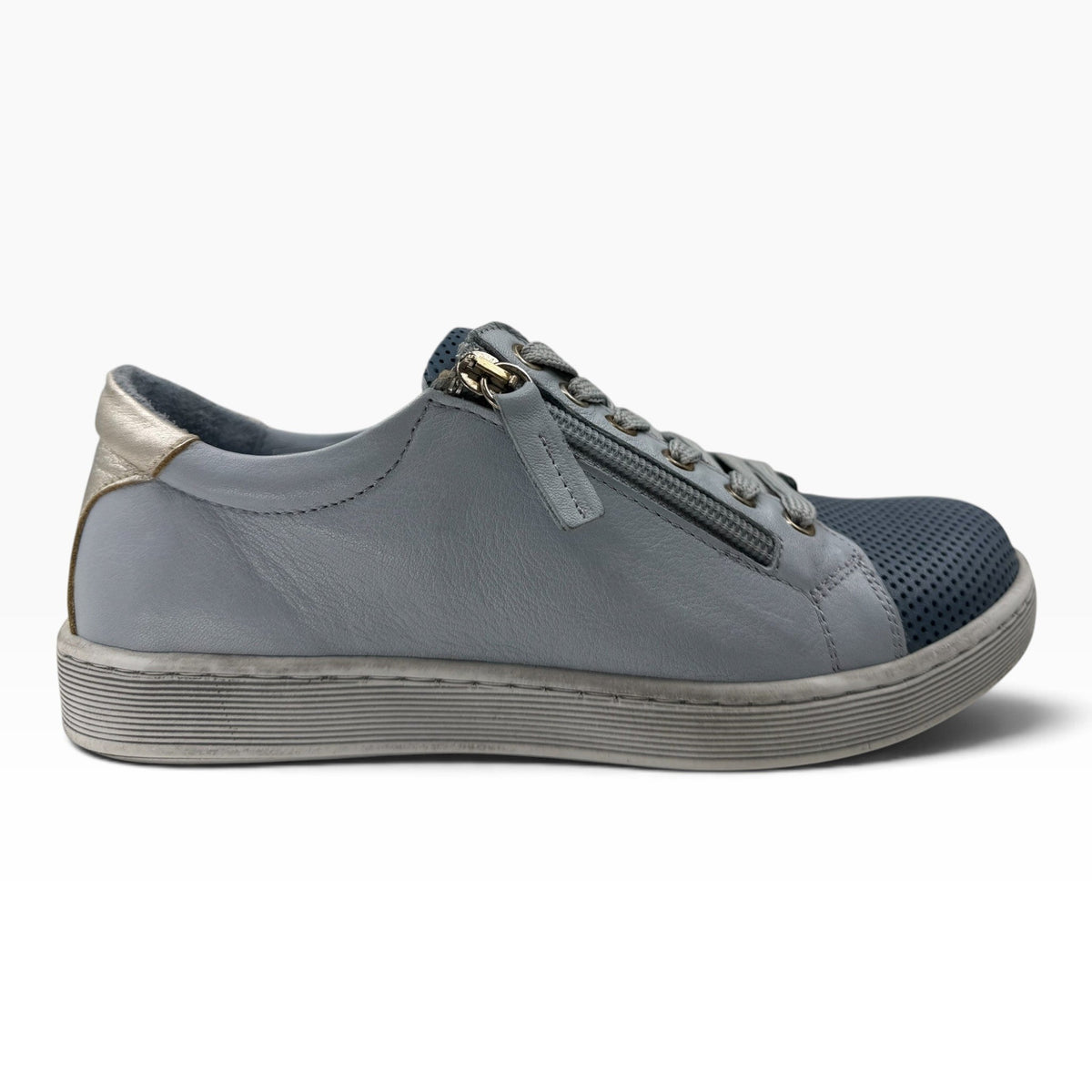 The Shoe Shop Tommie Perf grey leather sneaker with perforated toe, side zip, and metallic heel detail.