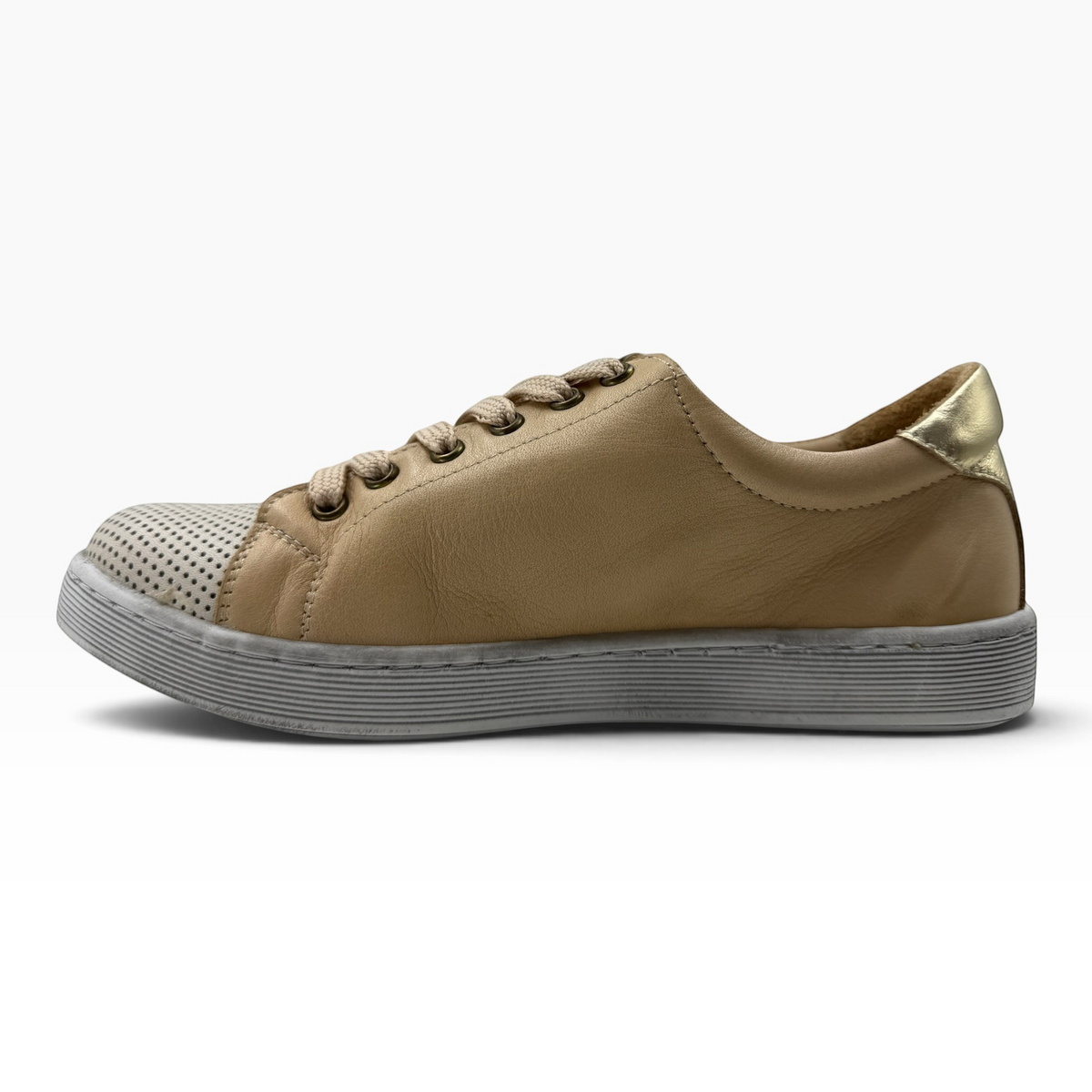 The Shoe Shop Tommie Perf leather sneaker in tan with perforated toe, metallic heel detail, and rubber sole.