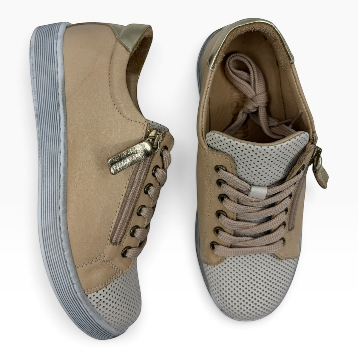 The Shoe Shop Tommie Perf beige leather sneakers with perforated toe, side zip, and metallic gold heel detail.