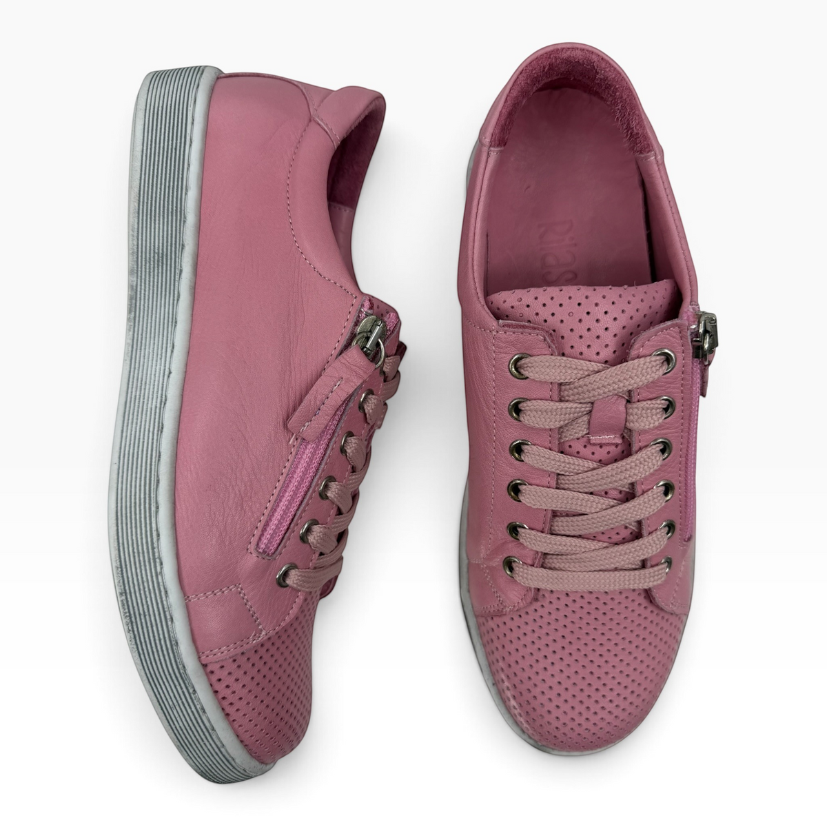 The Shoe Shop Tommie Perf pink leather sneakers with perforated detailing, lace-up front, and side zip closure.