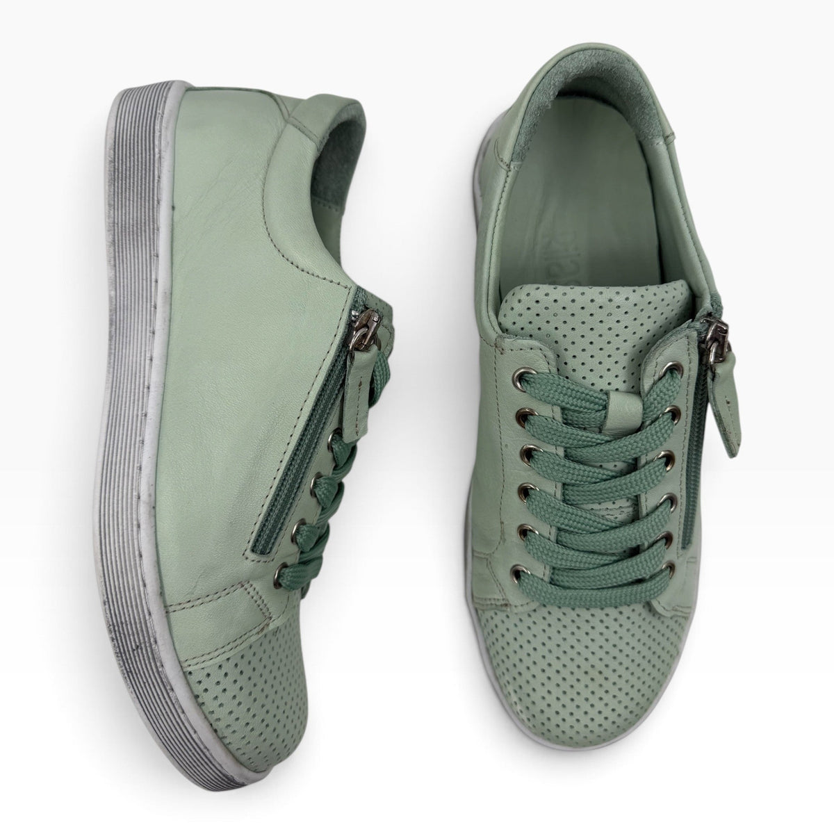 The Shoe Shop Tommie Perf sage green leather sneakers with perforated detailing, side zip, and lace-up closure.