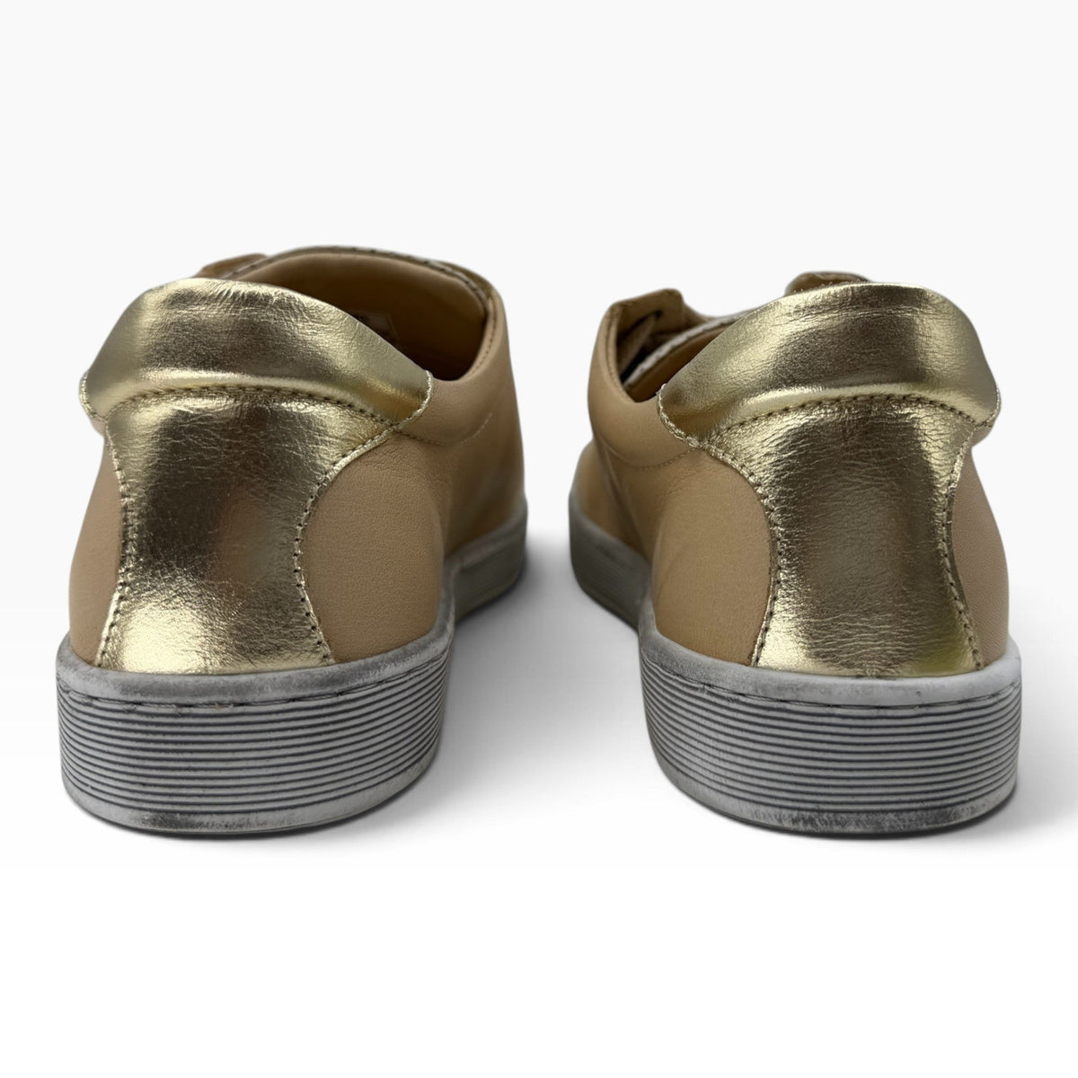 The Shoe Shop Tommie Perf sneakers in tan leather with metallic gold heel accents and durable rubber soles, rear view.
