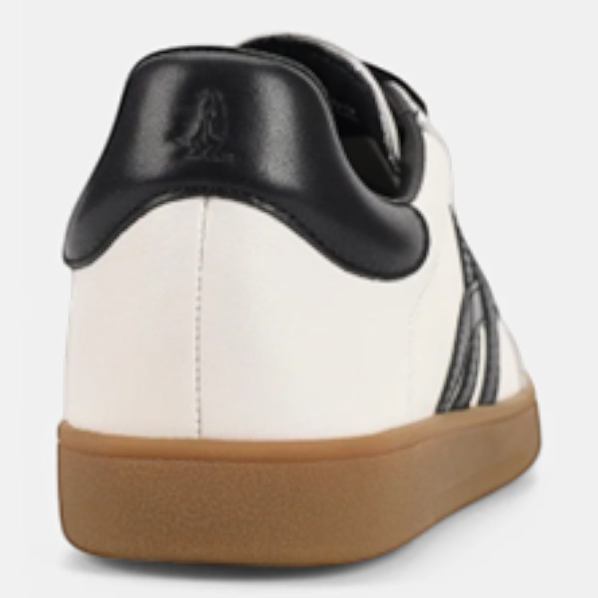 The Shoe Shop Trackside sneaker featuring a white suede upper, black leather heel tab, and a flexible gum rubber sole.