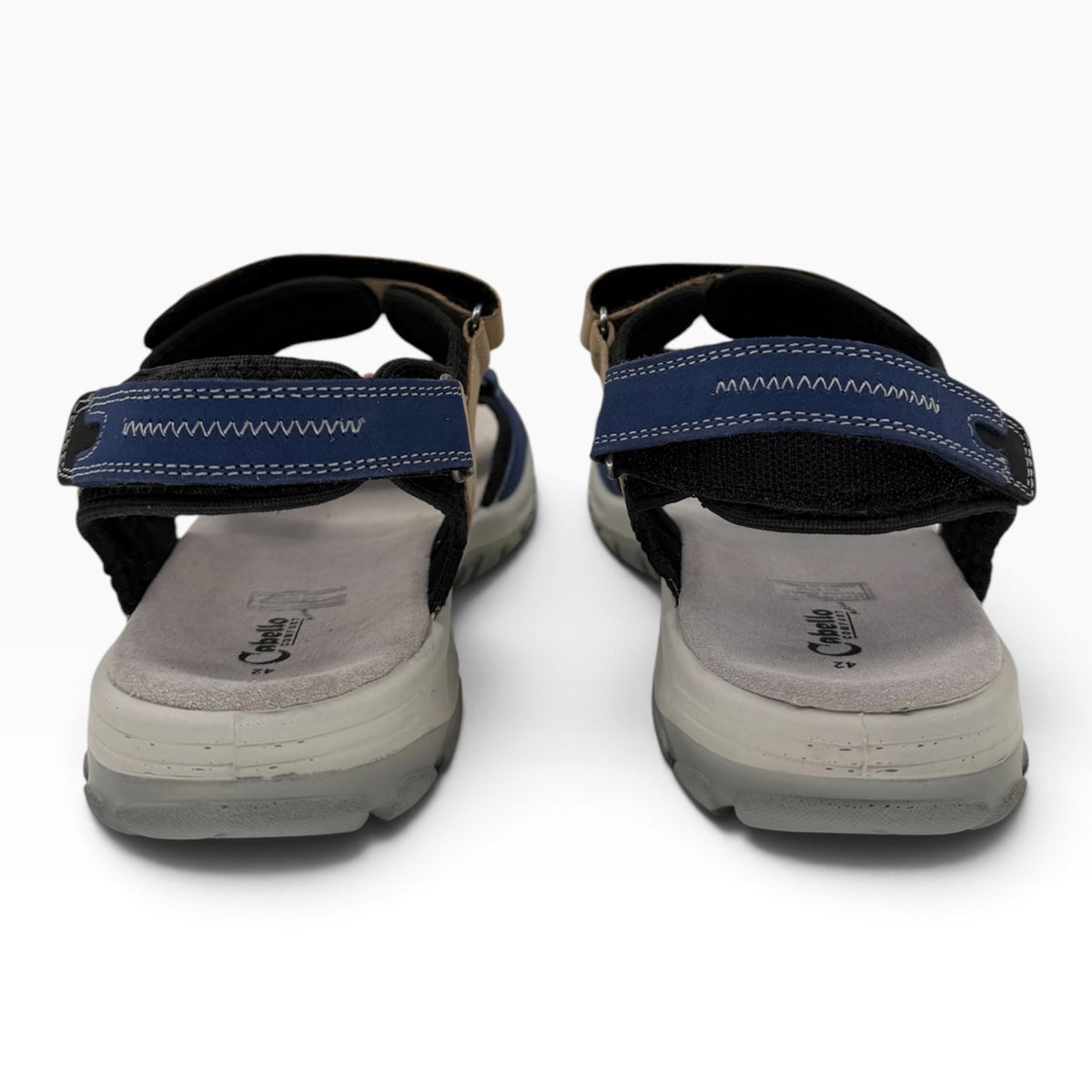 The Shoe Shop Trek sandals featuring blue and tan textile straps, moulded footbeds, and adjustable Velcro closures.