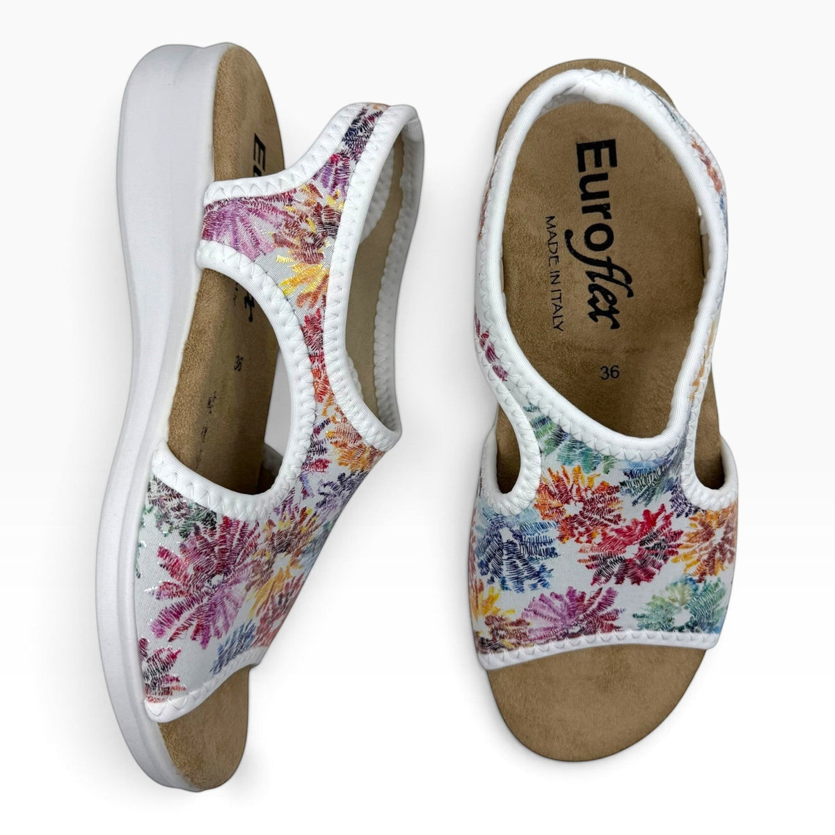 The Shoe Shop Tuscany vegan sandals featuring a white floral stretch upper and a comfortable low wedge sole
