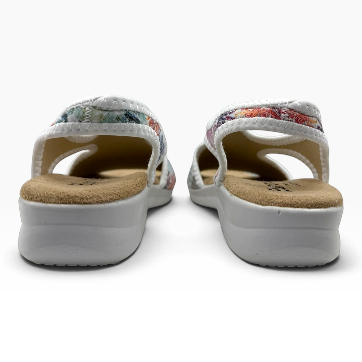 The Shoe Shop Tuscany vegan sandals featuring a floral stretch upper and comfortable low wedge sole, rear view.