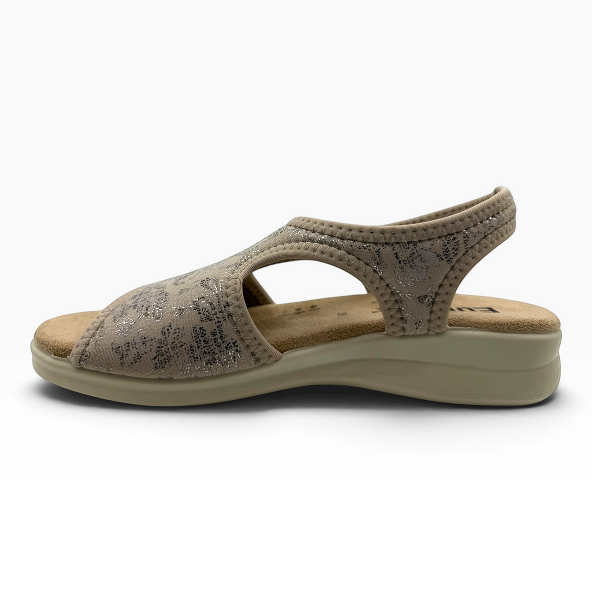 The Shoe Shop Tuscany vegan sandal in taupe with a floral pattern, featuring a cushioned low wedge and stretchy upper.