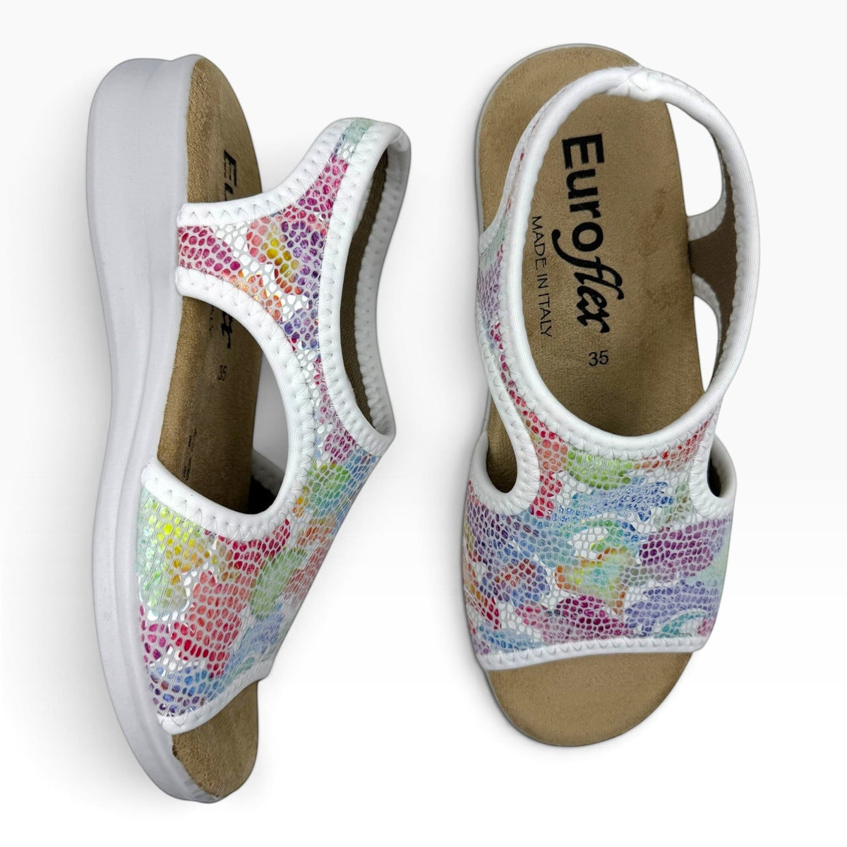 The Shoe Shop Tuscany vegan sandals with a white low wedge sole and a colorful snakeskin-patterned stretchy upper.