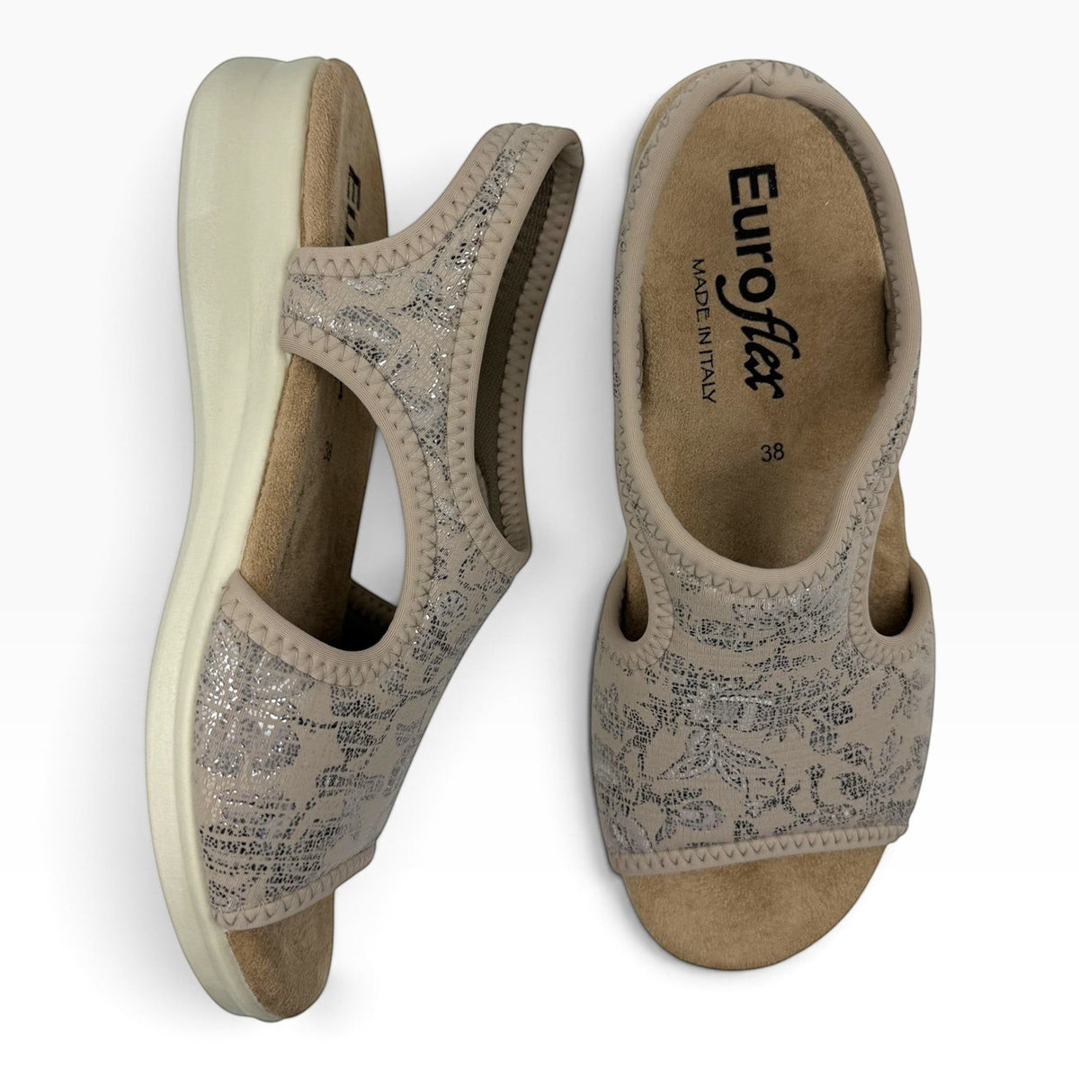The Shoe Shop Tuscany vegan sandals in beige with silver floral pattern, featuring a low wedge and flexible fit.