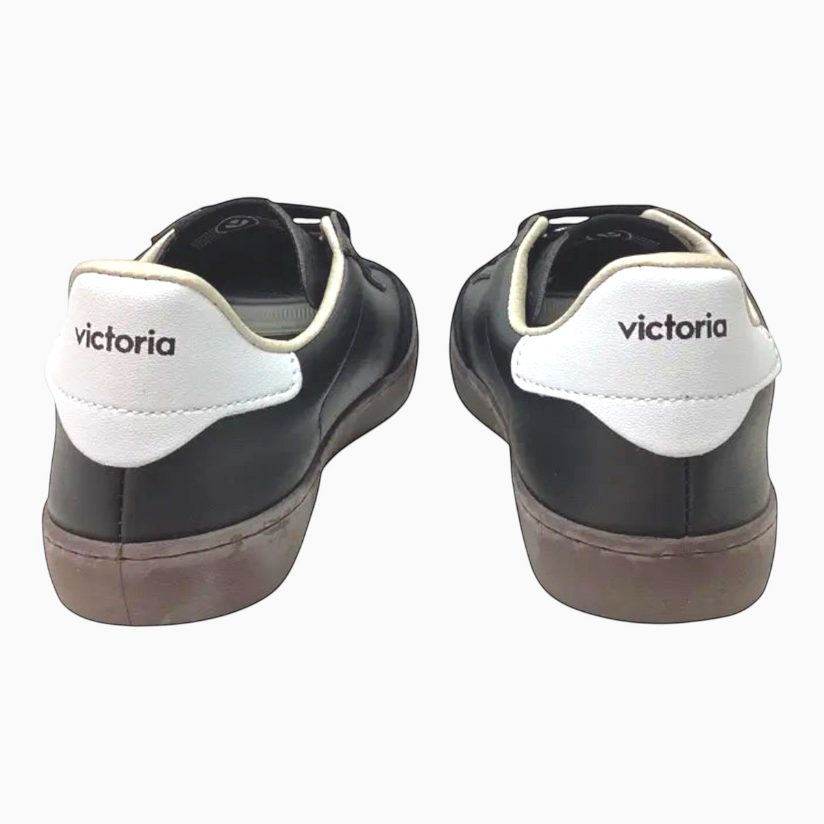 The Shoe Shop Victoria Berlin black leather sneakers with white heel tabs and Victoria branding, rear view.