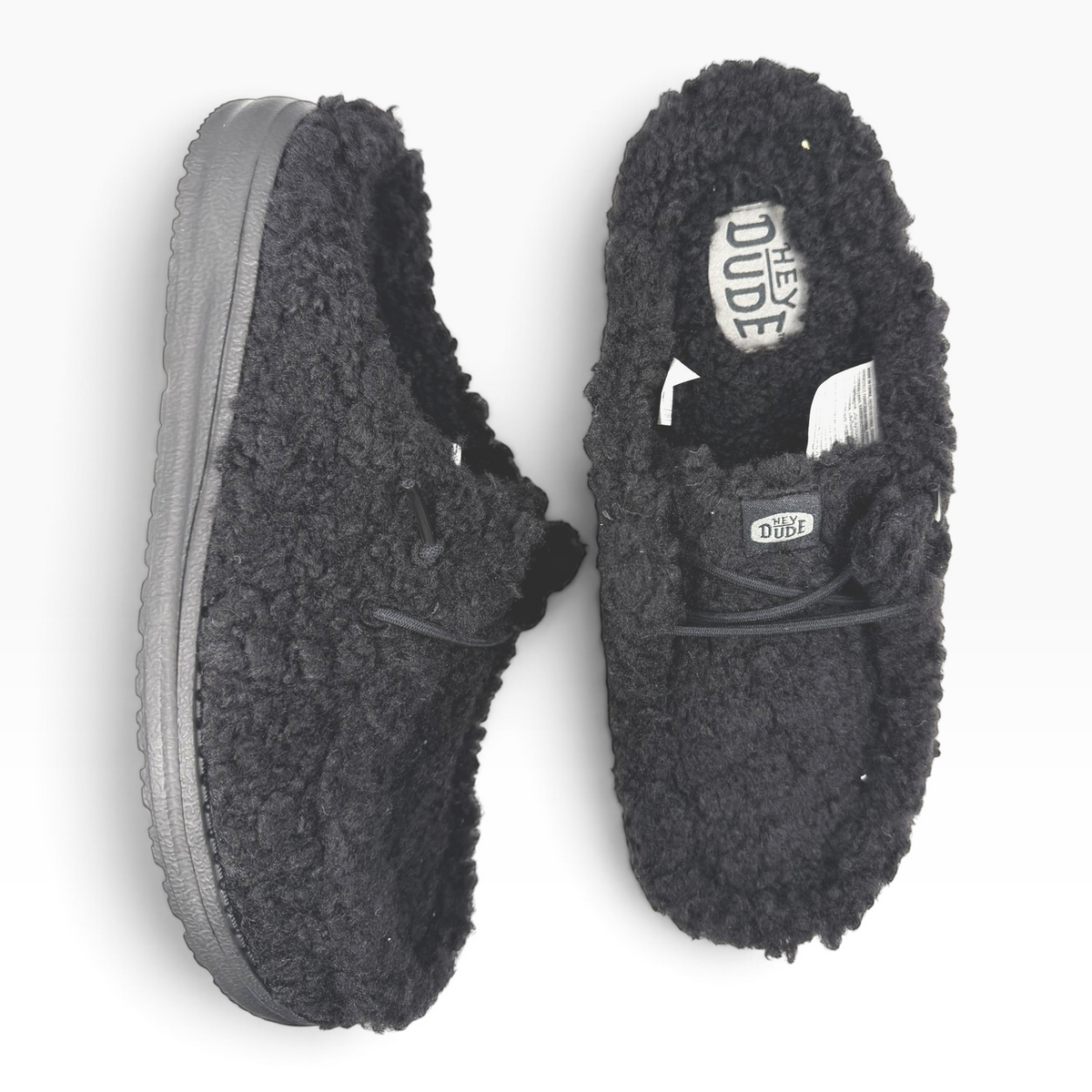 The Shoe Shop Wendy black fuzzy faux-fur slip-on shoes with a textured exterior and comfortable cushioned interior.