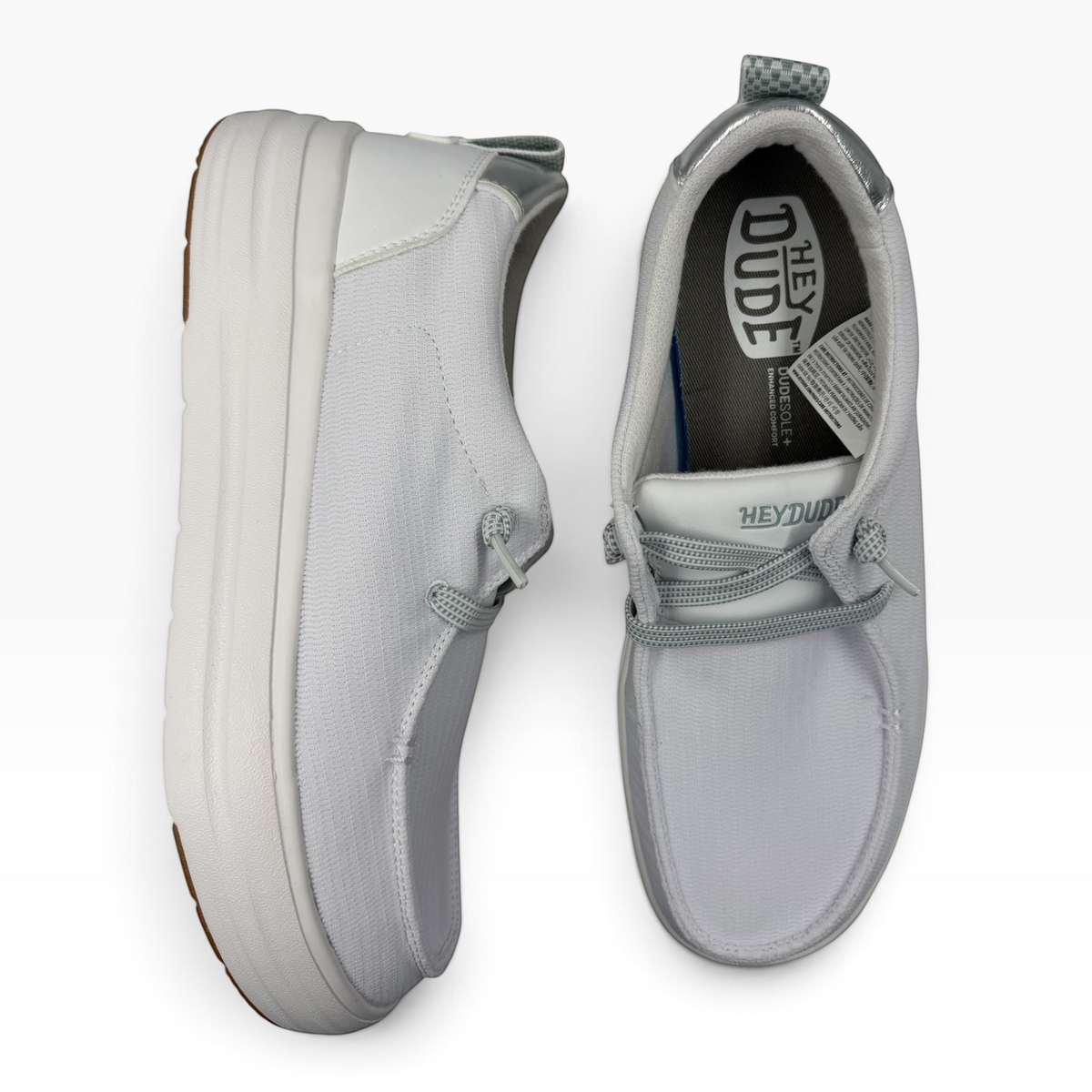 The Shoe Shop Wendy Nova Knit light grey slip-on sneakers with metallic silver accents and a thick white platform sole.