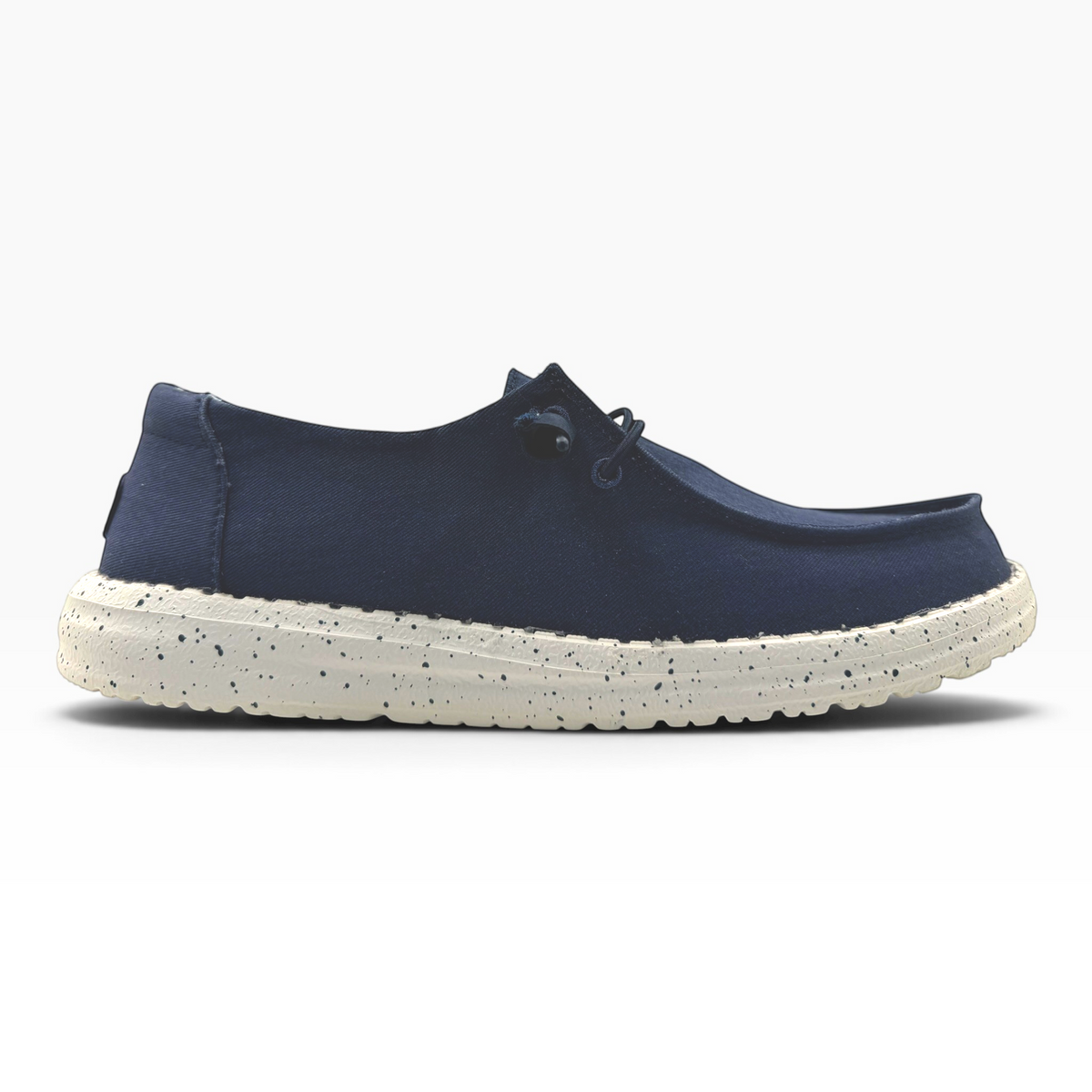 The Shoe Shop Wendy Stretch navy blue slip-on shoe with a speckled white cushioned sole, side profile view.