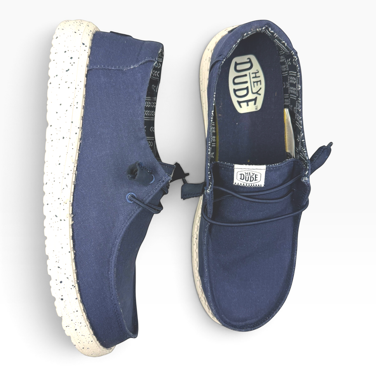 The Shoe Shop Wendy Stretch navy blue slip-on shoes with a speckled white sole and patterned interior lining.