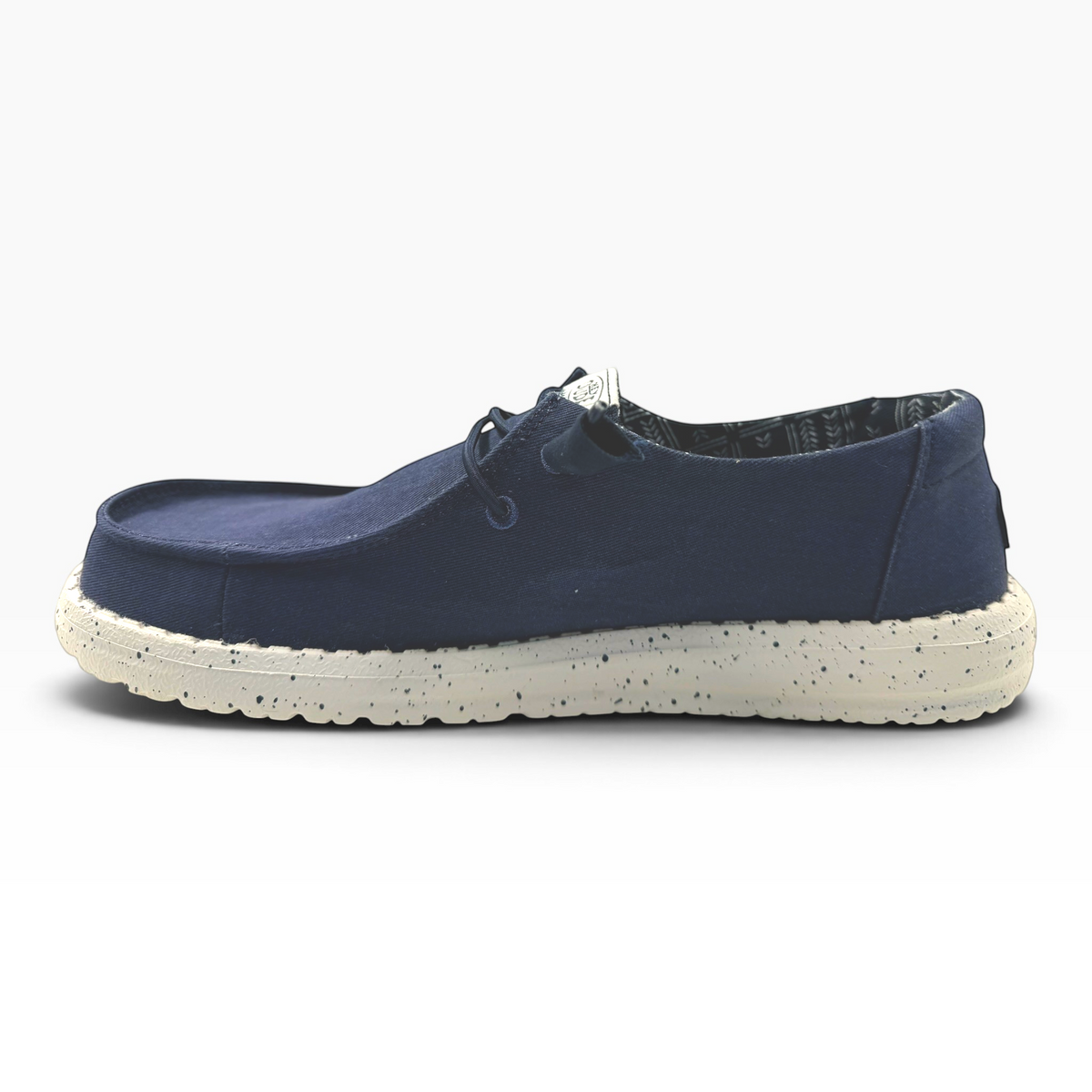 The Shoe Shop Wendy Stretch navy blue slip-on shoe with a speckled white cushioned sole, side profile view.