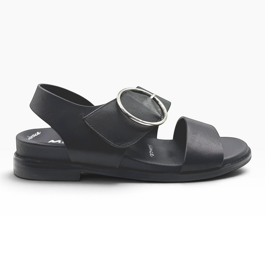 The Shoe Shop Willa black leather flat sandal with a silver circular buckle and adjustable strap