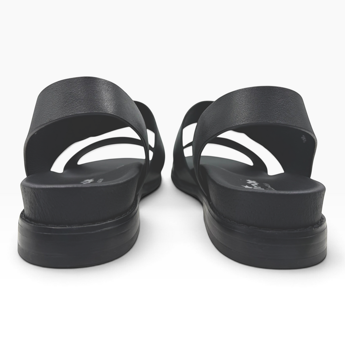 The Shoe Shop Willa black leather sandals featuring a comfortable slingback strap and a flat sole, rear view.