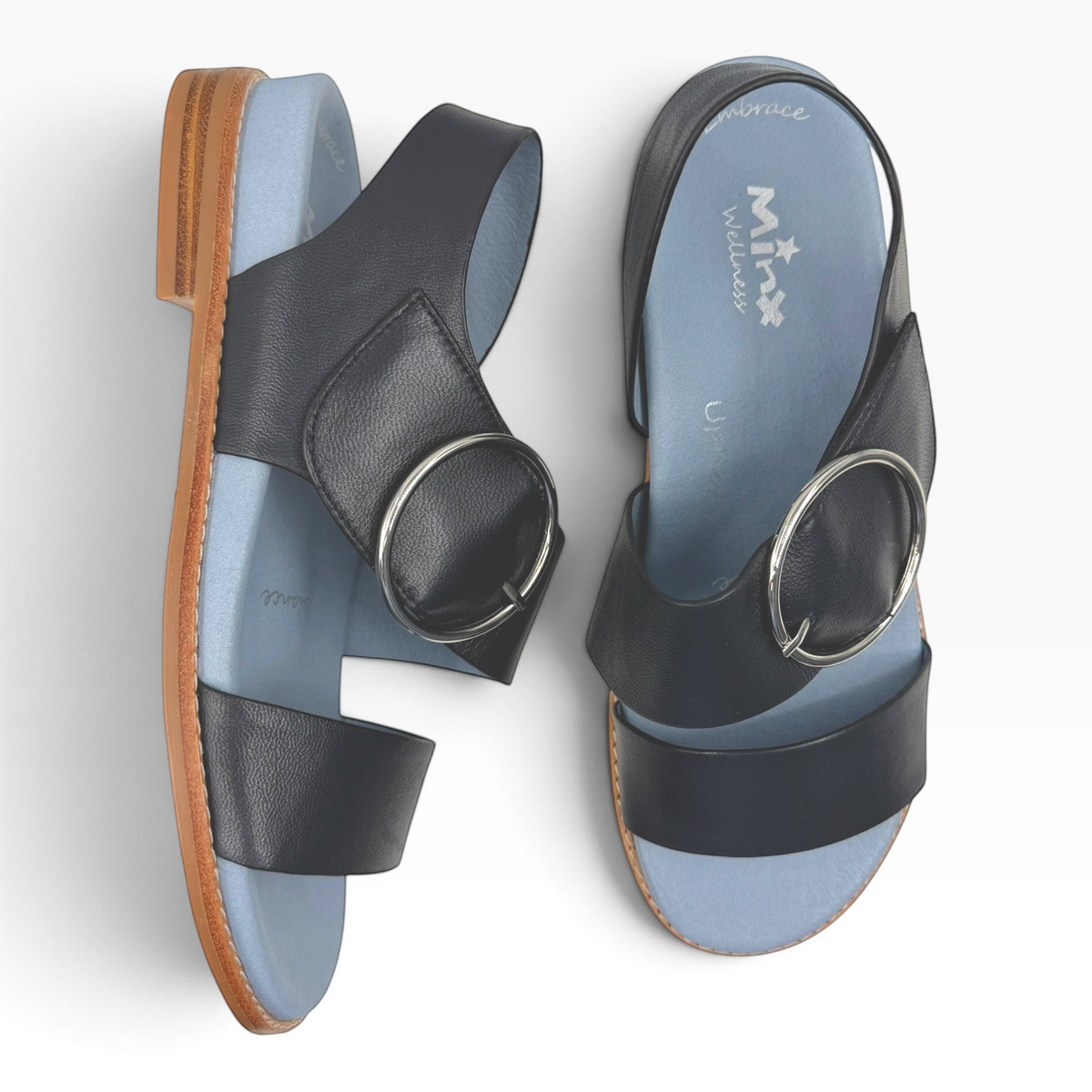 The Shoe Shop Willa black leather flat sandals with silver buckle detail and light blue cushioned footbed