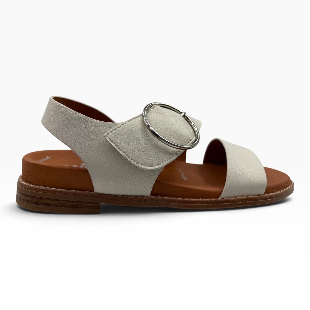 The Shoe Shop Willa white leather sandal with a large silver circular buckle and a flat brown footbed