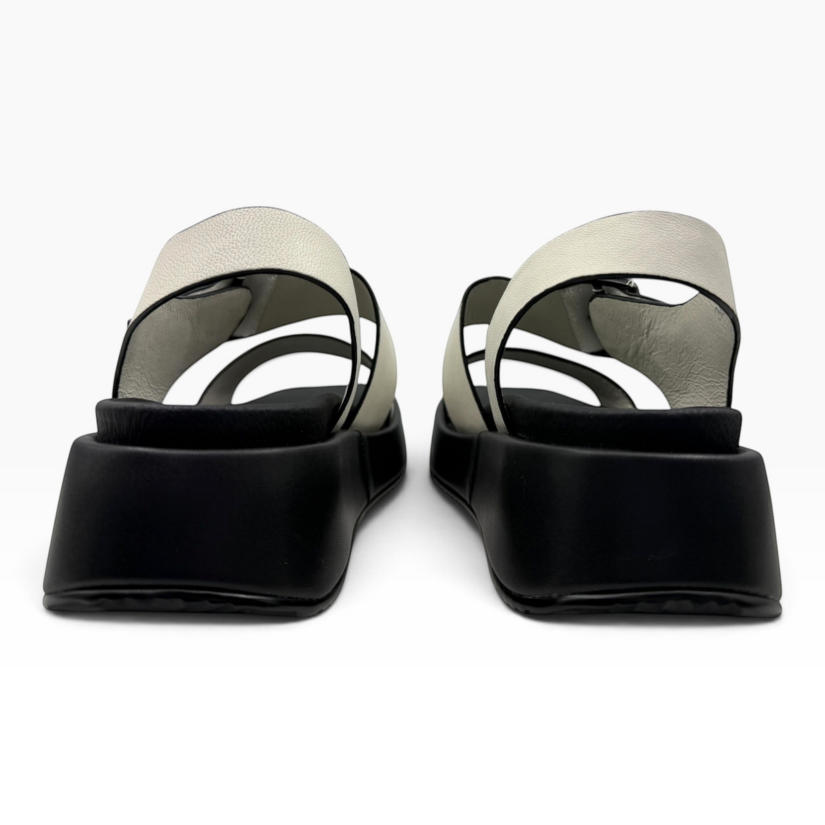 The Shoe Shop Zen platform sandals featuring white leather straps and a chunky black sole, rear view.