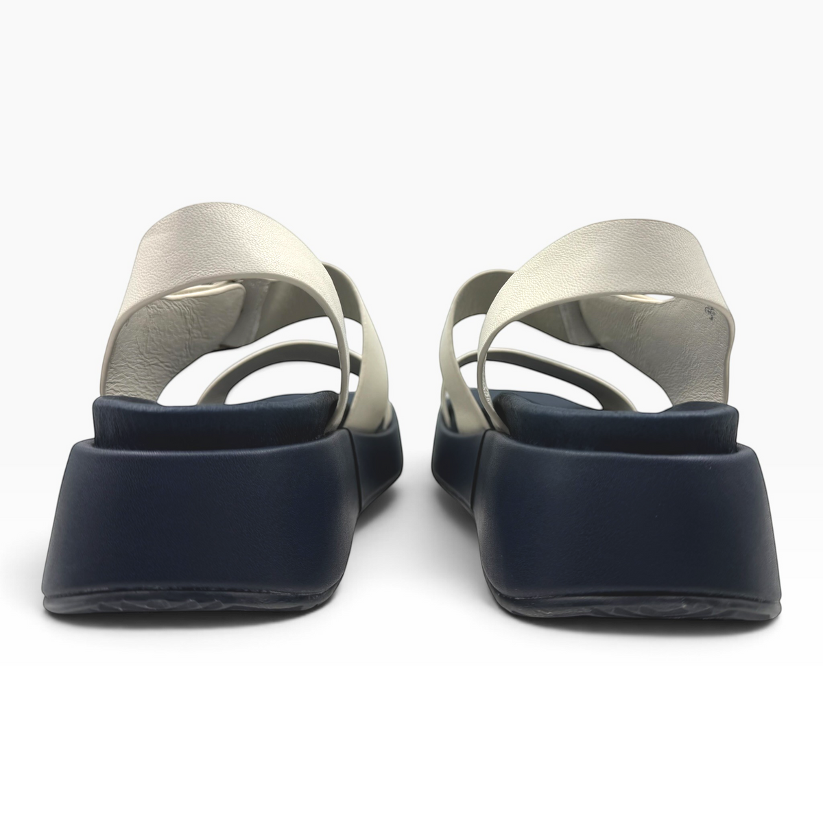 The Shoe Shop Zen platform sandals featuring light grey straps and a thick navy blue sole, back view
