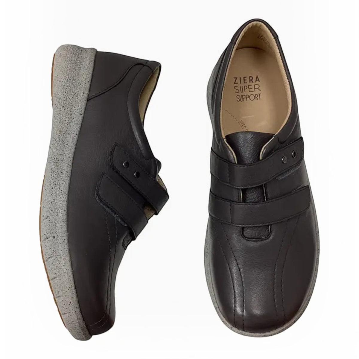 The Shoe Shop Ziera Sonnye black leather sneakers with hook-and-loop straps, thick grey soles, and arch support.